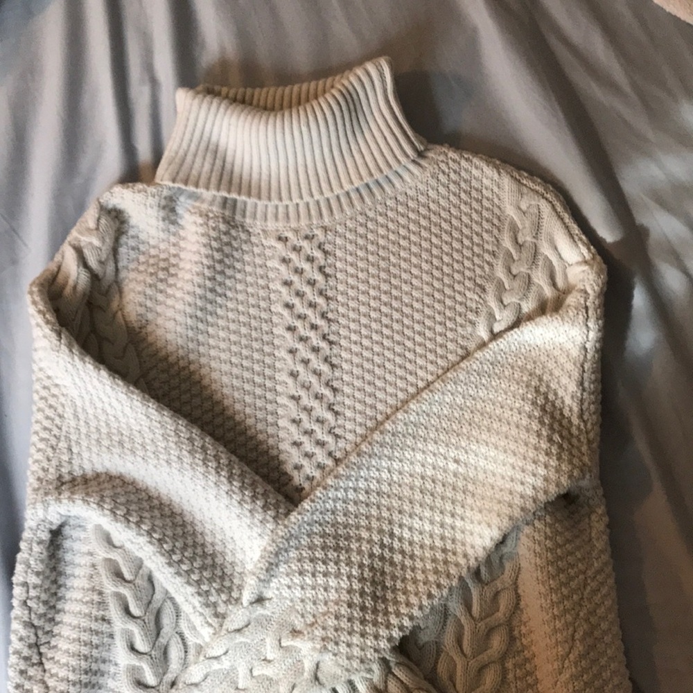 Off white turtleneck sweater.